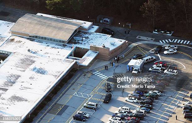 People gather at the scene of a mass school shooting at Sandy Hook Elementary School on December 14, 2012 in Newtown, Connecticut. There are 27 dead,...