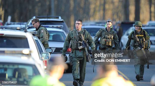 State Police inspect the area on December 14, 2012 at the aftermath of a school shooting at a Connecticut elementary school that brought police...