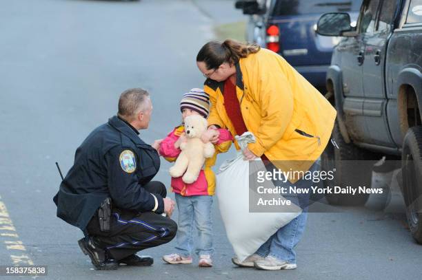 Child and her mother leave staging area outside Sandy Hook Elementary School in Newtown, CT. A gunman opened fire inside school killing 27 people,...