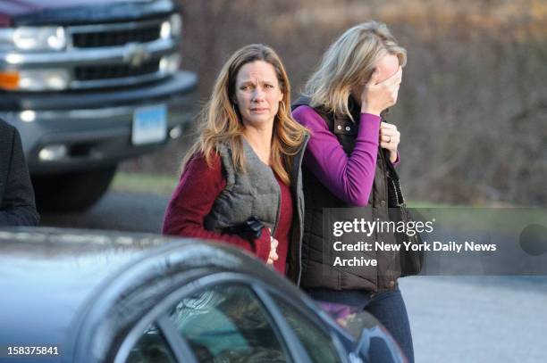 People leave staging area outside Sandy Hook Elementary School in Newtown, CT. A gunman opened fire inside school killing 27 people, including 20...