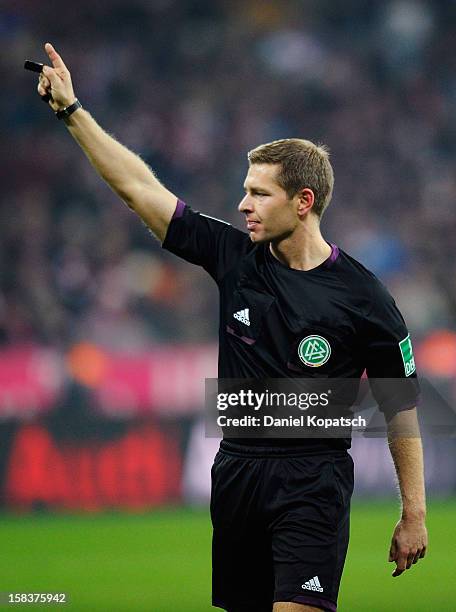 Referee Tobias Welz gestures during the Bundesliga match between FC Bayern Muenchen and VfL Borussia Moenchengladbach at Allianz Arena on December...