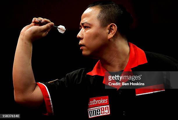 Leung Chun Nam of Hong Kong in action during his preliminary match on day one of the Ladbrokes.com World Darts Championship at Alexandra Palace on...