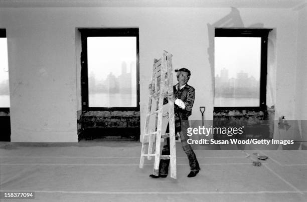 American fashion designer Ralph Lauren carries a ladder in his 5th Avenue apartment during renovations, New York New York, November 1977.