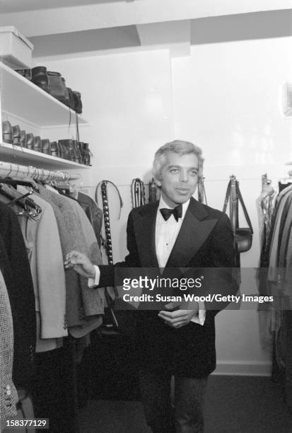 Portrait of American fashion designer Ralph Lauren, in a walk-in closet, as he dresses for a night out, New York New York, November 1977. He and his...