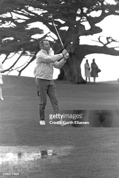 During the Bing Crosby National Pro-Amateur golf tournament, American actor Jack Lemmon watches his shot from the fairway on the course near the 18th...