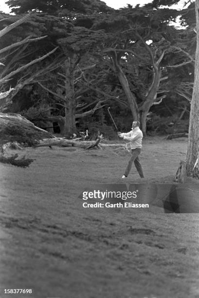 During the Bing Crosby National Pro-Amateur golf tournament, American actor Jack Lemmon plays out of the rough on the course near the 17th hole at...