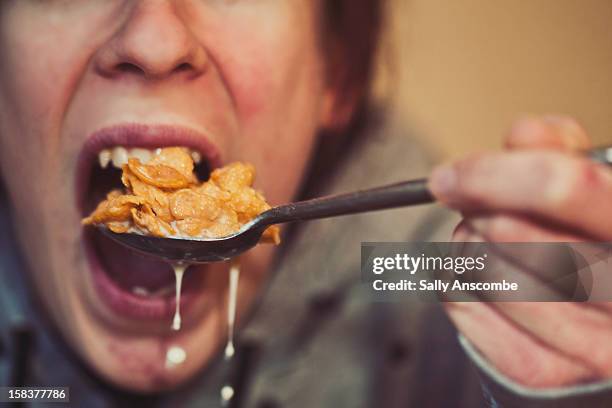 teenage girl eating cereal and milk - corn flakes imagens e fotografias de stock