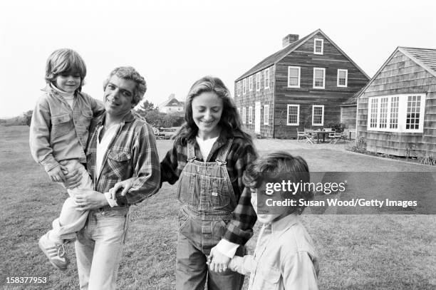 American fashion designer Ralph Lauren and his wife, therapist Ricky Lauren, walk outside their home, with two of their three children , East...