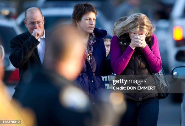 Distraught leave the fire station after hearing news of their loved ones from officials December 14, 2012 in Newtown, Connecticut. A young gunman...