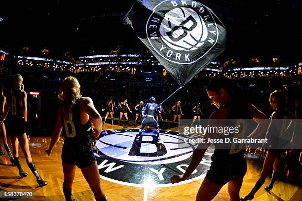 The Brooklyn Knight, mascot of the Brooklyn Nets, waves a flag during opening ceremonies before a game against the Detroit Pistons at the Barclays...