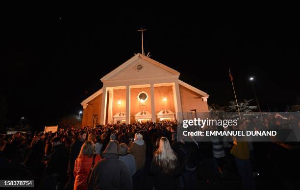 People gather for a prayer vigil at St Rose Church following an elementary school shooting in Newtown, Connecticut, December 14, 2012. A young gunman...