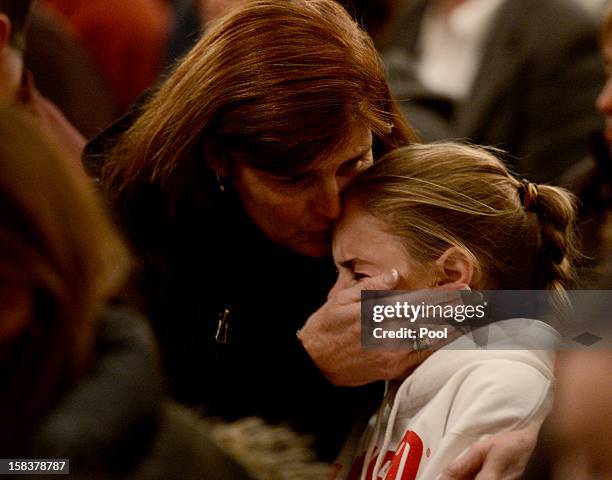 Mourners gather inside the St. Rose of Lima Roman Catholic Church at a vigil service for victims of the Sandy Hook School shooting December 14, 2012...