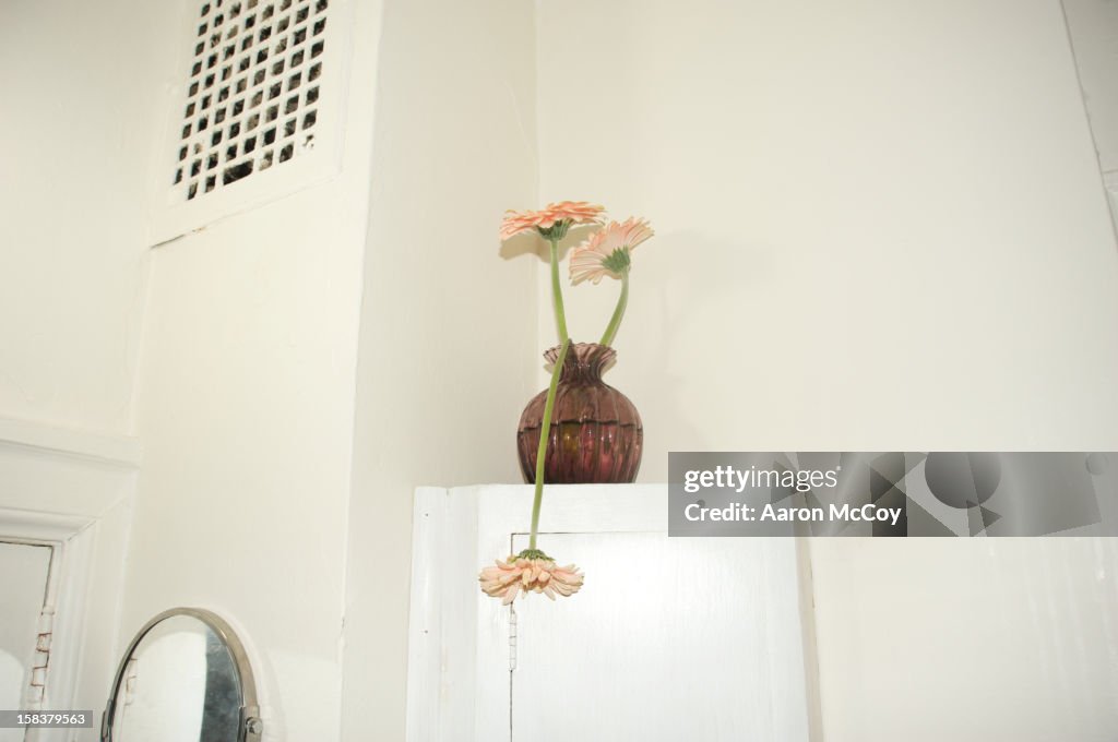 A flower drooping over in vase