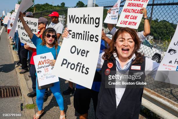 Boston, MA Evelyn Thomas, left, and Karina Touchette, both employees of Avis Car Rental, attend a rally in front of Avis Budget Group Local's...