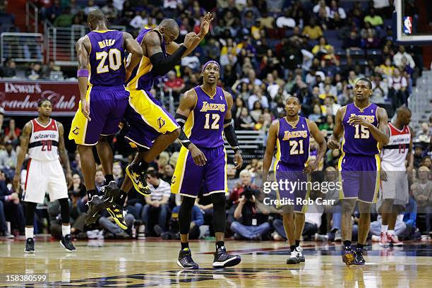 Jodie Meeks and Kobe Bryant of the Los Angeles Lakers celebrate during the closing minutes of the Lakers 102-96 win over the Washington Wizards at...