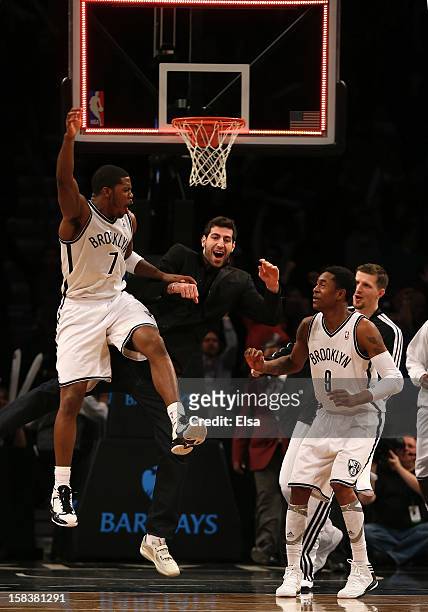 Joe Johnson of the Brooklyn Nets celebrates his game winning basket with teammate MarShon Brooks in double overtime against the Detroit Pistons on...