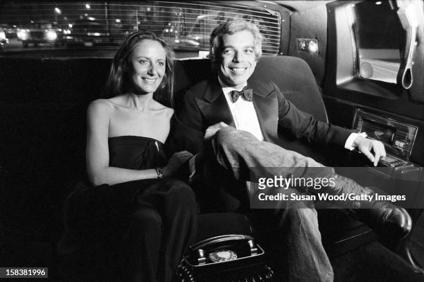 American fashion designer Ralph Lauren and his wife, therapist Ricky Lauren, smile in the backseat of a limosine, New York, November 1977. The pair...