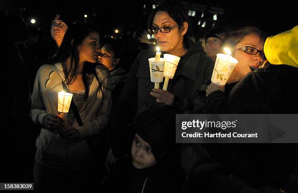 Approximately 100 people attended a candlelight vigil at Hartford, Connecticut's Bushnell Park on Friday, December 14 to honor the students and...