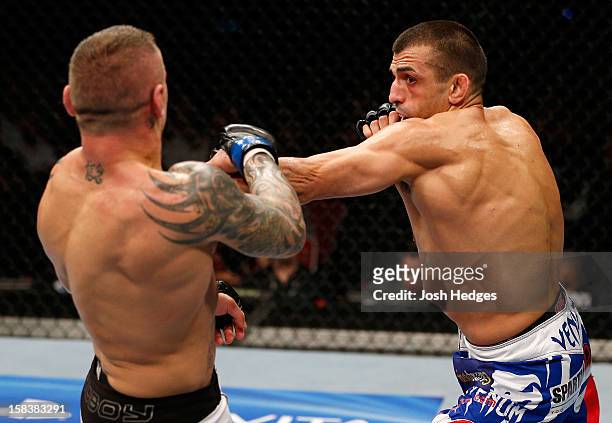 George Sotiropoulos punches Ross Pearson during their lightweight fight at the UFC on FX event on December 15, 2012 at Gold Coast Convention and...