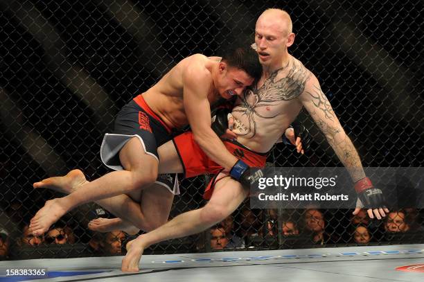 Norman Parke lifts Colin Fletcher during the Lightwieght final bout between Colin Fletcher and Norman Parke at Gold Coast Convention and Exhibition...