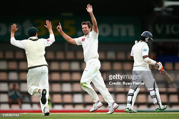 Ben Hilfenhaus of Australia celebrates after taking the wicket of Dimuth Karunaratne of Sri Lanka during day two of the First Test match between...