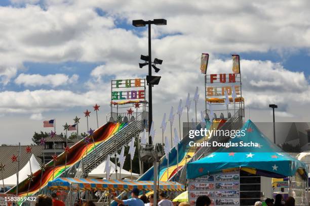 traditional state fair with midway attractions - anticipation rollercoaster stock pictures, royalty-free photos & images