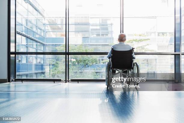 senior man in wheelchair - nursing home interior stock pictures, royalty-free photos & images