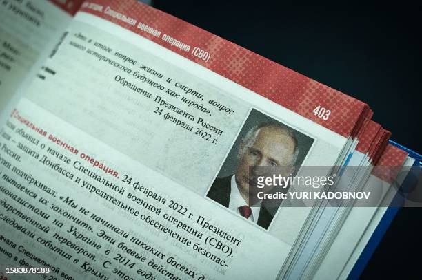 Portrait of Russian President Vladimir Putin is seen on a page of a new schoolbook for high school students on general world history and Russian...
