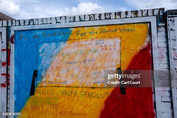 Pro-democracy messages are written on an area of wall that had been graffitied with Chinese Communist Party ideology, on August 7, 2023 in Brick...