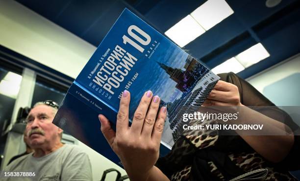 Media representative looks through a new schoolbook for high school students on general world history and Russian history, mentioning the the...