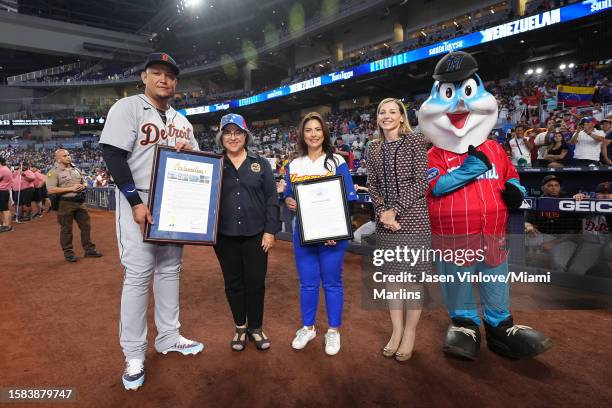 Miguel Cabrera of the Detroit Tigers poses for a photo with Caroline O'Connor President of Business Operations of the Miami Marlins Miami-Dade Mayor...