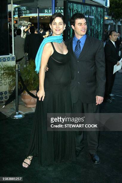 Actress Carrie-Anne Moss with her husband Steven Roy arrives at the premiere for The Matrix Reloaded in which she stars in, at the Mann Village...