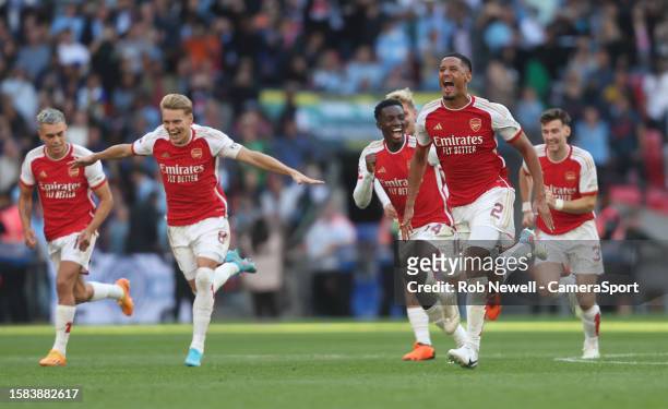 Arsenal's William Saliba leads the celebrations as his side win the penalty shoot-out during The FA Community Shield match between Manchester City...