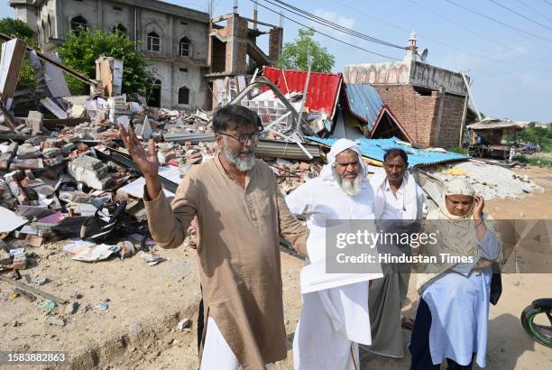 Abdul Rashid showing their property paper outside demolished shops in Nalhar village near Shaheed Hasan Khan Mewati Medical College after District...