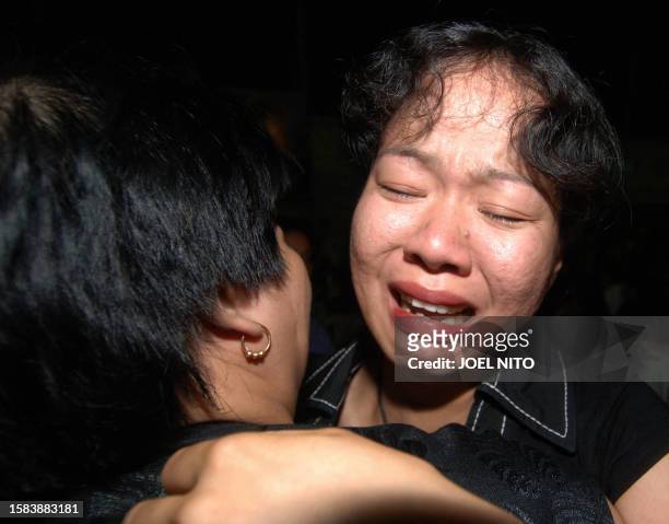 Philippine worker Hazel Verinia is embraced by her mother as she disembarks from an aeroplane at Villamor Air Base, Manila, 25 July 2006, after...