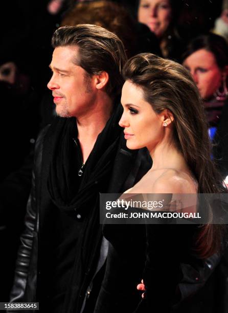 Actor Brad Pitt and actress Angelina Jolie pose for photographers as they arrive for the European premiere of the film "The Tourist", by German...