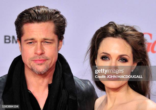 Actor Brad Pitt and actress Angelina Jolie pose for photographers as they arrive for the European premiere of the film "The Tourist", by German...