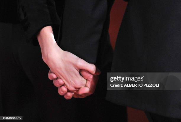 The hands of US actors Brad Pitt and Angelina Jolie pose as they arrive for the premiere of her movie The Tourist by German director Florian Henckel...