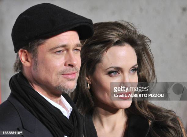 Actors Brad Pitt and Angelina Jolie pose as they arrive for the premiere of her movie The Tourist by German director Florian Henckel von Donnersmarck...