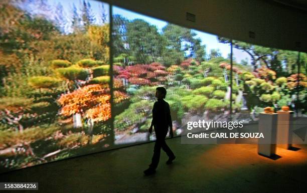 Barbican employee walks past a film installation by New York based artist Peter Coffin at the Curve Gallery in the Barbican arts centre, in London,...