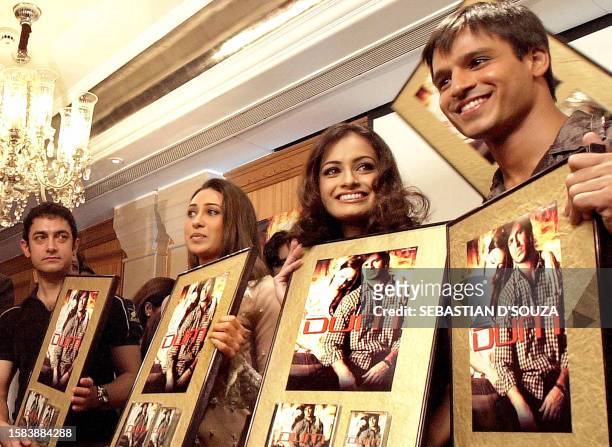 Bollywood actors Amir Khan , Karisma Kapoor former miss India Diya Mirza and actor Vivek Oberoi hold posters of the movie 'DUM' in Bombay, 29...
