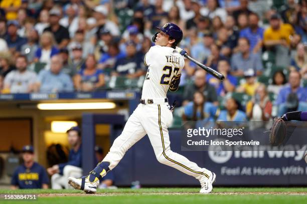 Milwaukee Brewers left fielder Christian Yelich hits a single in the fourth inning during a regular season game between the Colorado Rockies and...