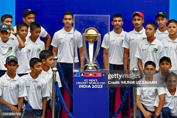 Students from Bangladesh's sports institute pose with the ICC Men's Cricket World Cup 2023 trophy at the Sher-e-Bangla National Cricket Stadium in...