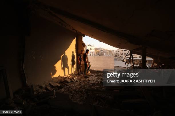 Men inspect the remains of a house which Israeli soldiers demolished at the Asker camp for Palestinian refugees east of Nablus city in the occupied...