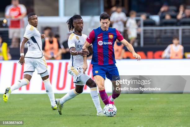 Barcelona forward Robert Lewankowski dribbles the ball as Real Madrid midfielder Eduardo Camavinga applies pressure during the Soccer Champions Tour...