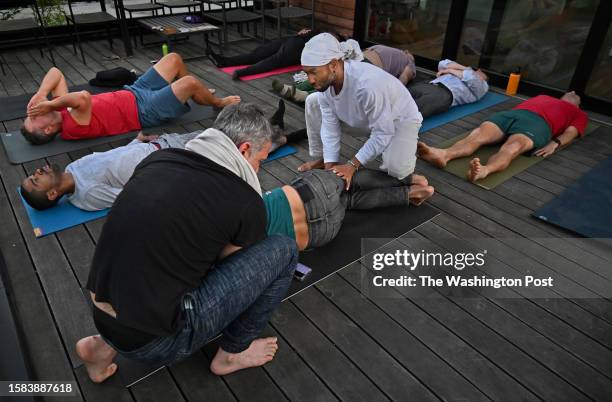 Group of men meditate on a balcony at a home in Washington, D.C. On April 13, 2023. Joshua Cogan and Rua Williamson comforted a man experiencing some...