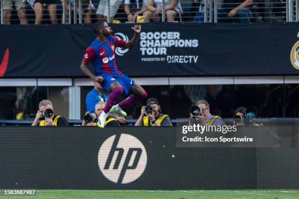 Barcelona forward Ousmane Dembele celebrates after scoring a goal during the Soccer Champions Tour match between Real Madrid and FC Barcelona on July...