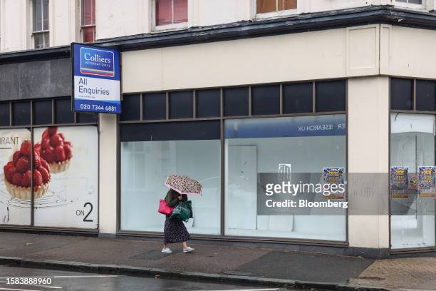 Pedestrian passes a vacant retail unit on the high street in Eastbourne, UK, on Saturday, Aug. 5, 2023. A jobs boom in Britain's seaside towns is...