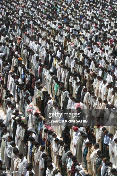 Iraqis attend the Friday noon prayers at al-Kufa mosque in Iraq's holy Shiite city of Najaf, some 180 kms south of Baghdad, 02 May 2003. Iraqis were...