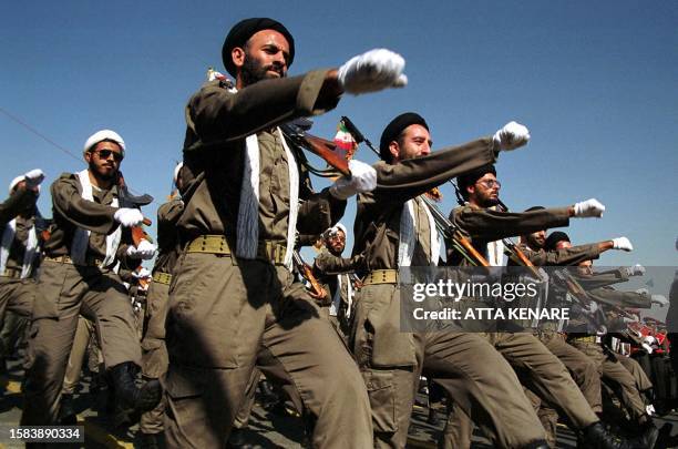 Armed Iranian mullahs march during a military parade in Tehran 21 September 2000, marking the 20 th anniversary of the war with Iraq. Iran is staging...